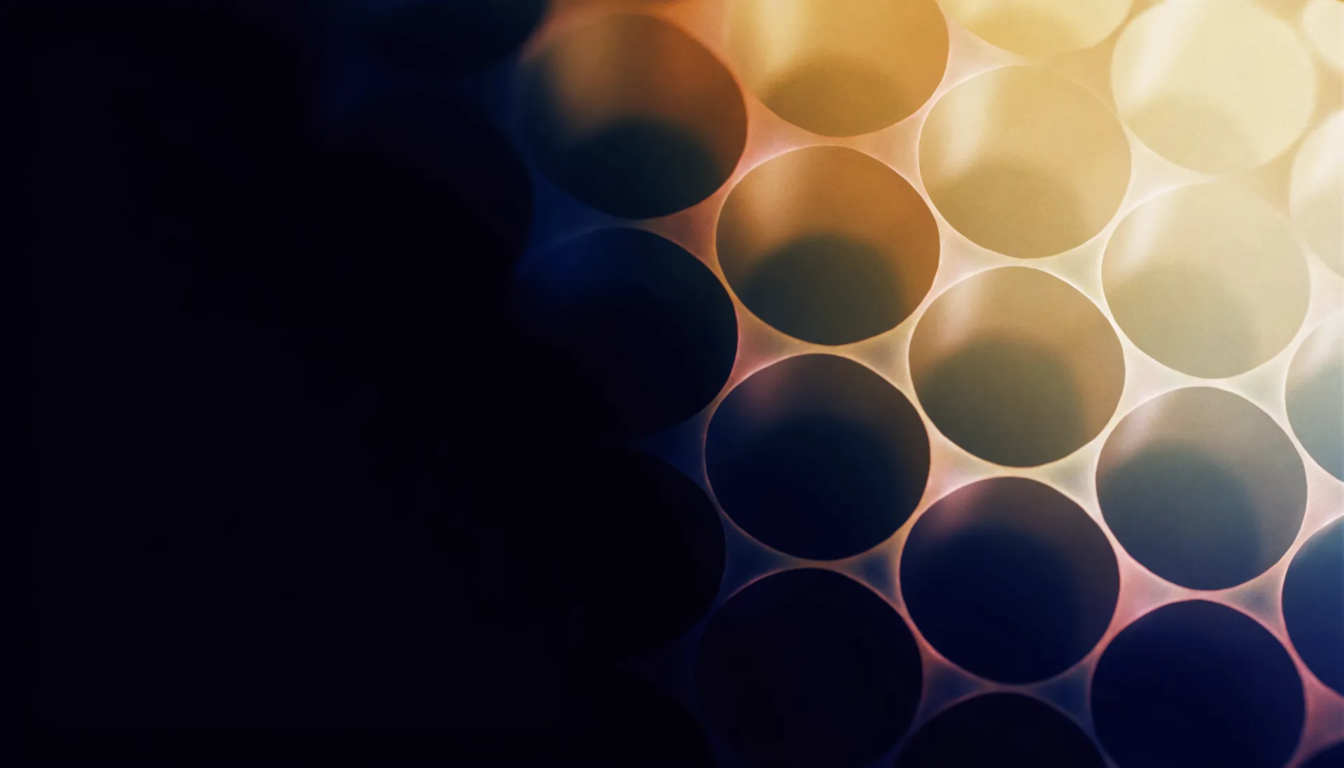 A warm brass and rose hexagonal lattice of light